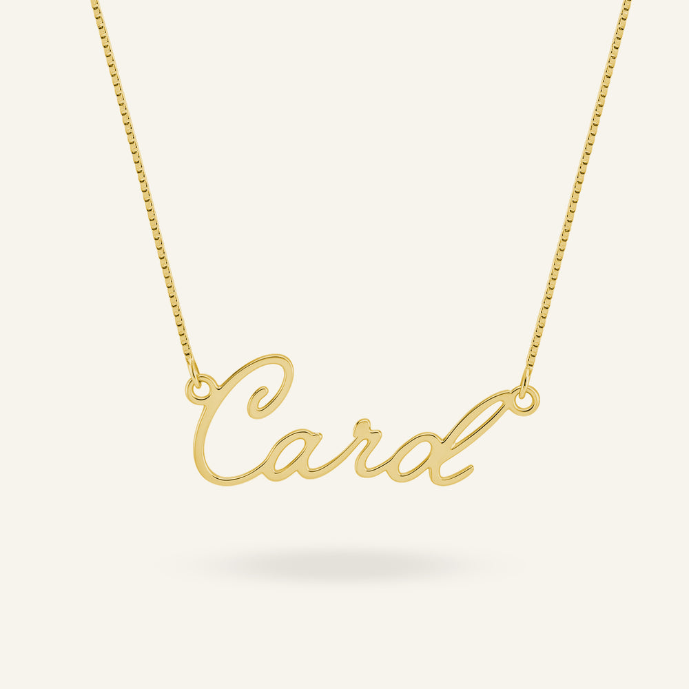 Gold-plated custom name necklace displaying "Card" in elegant calligraphy script, on a light background.