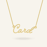 Gold-plated custom name necklace displaying "Card" in elegant calligraphy script, on a light background.