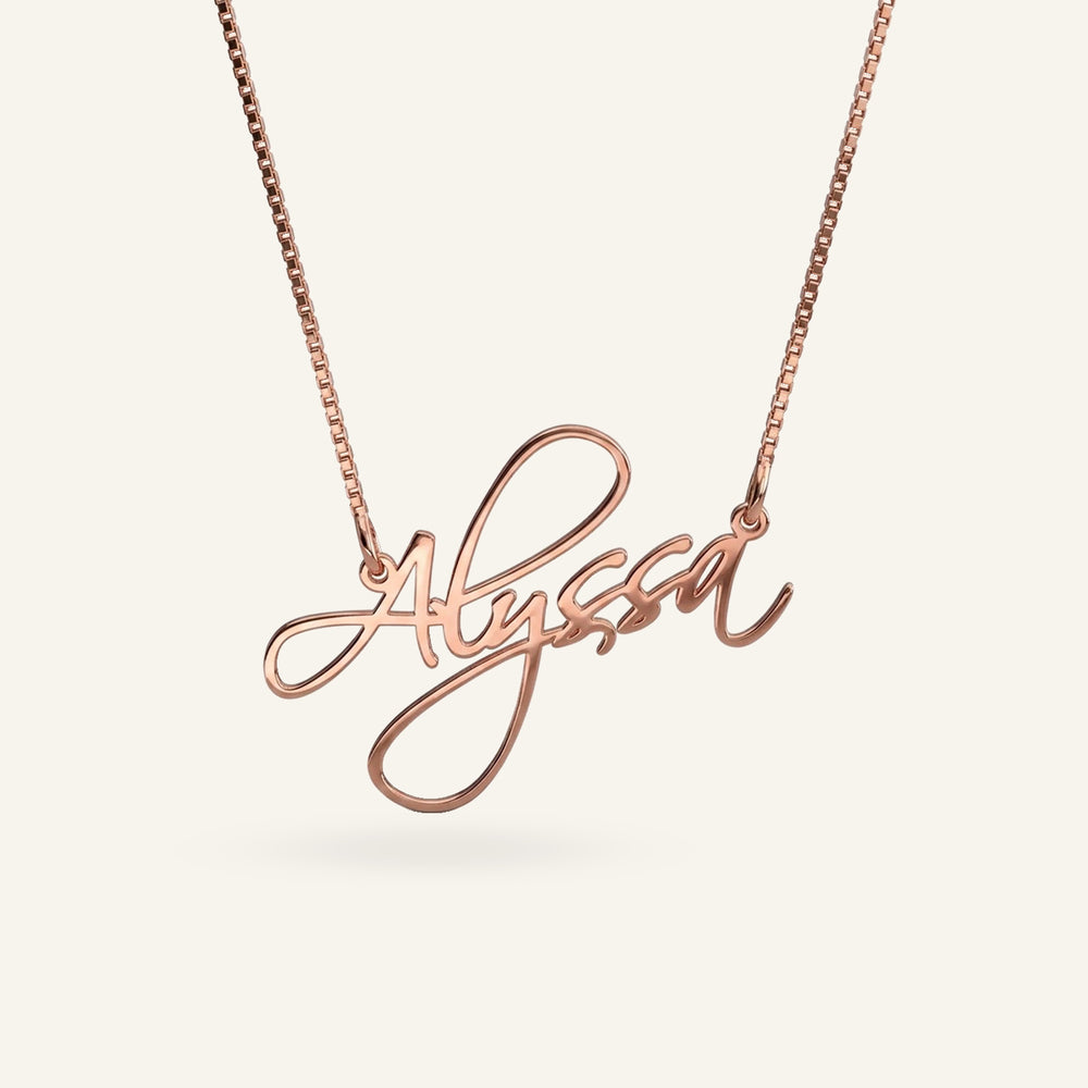 Rose gold plated sterling silver name necklace with "Alyssa" in elegant script, featuring a box chain.